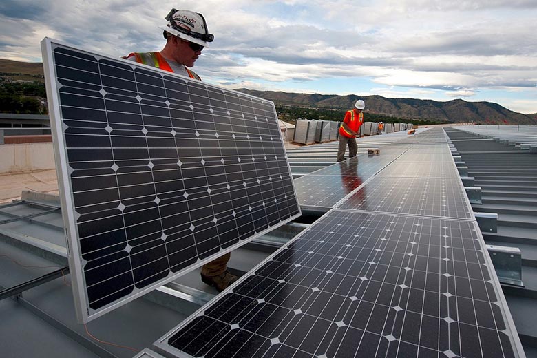 Energy technicians installing solar panels